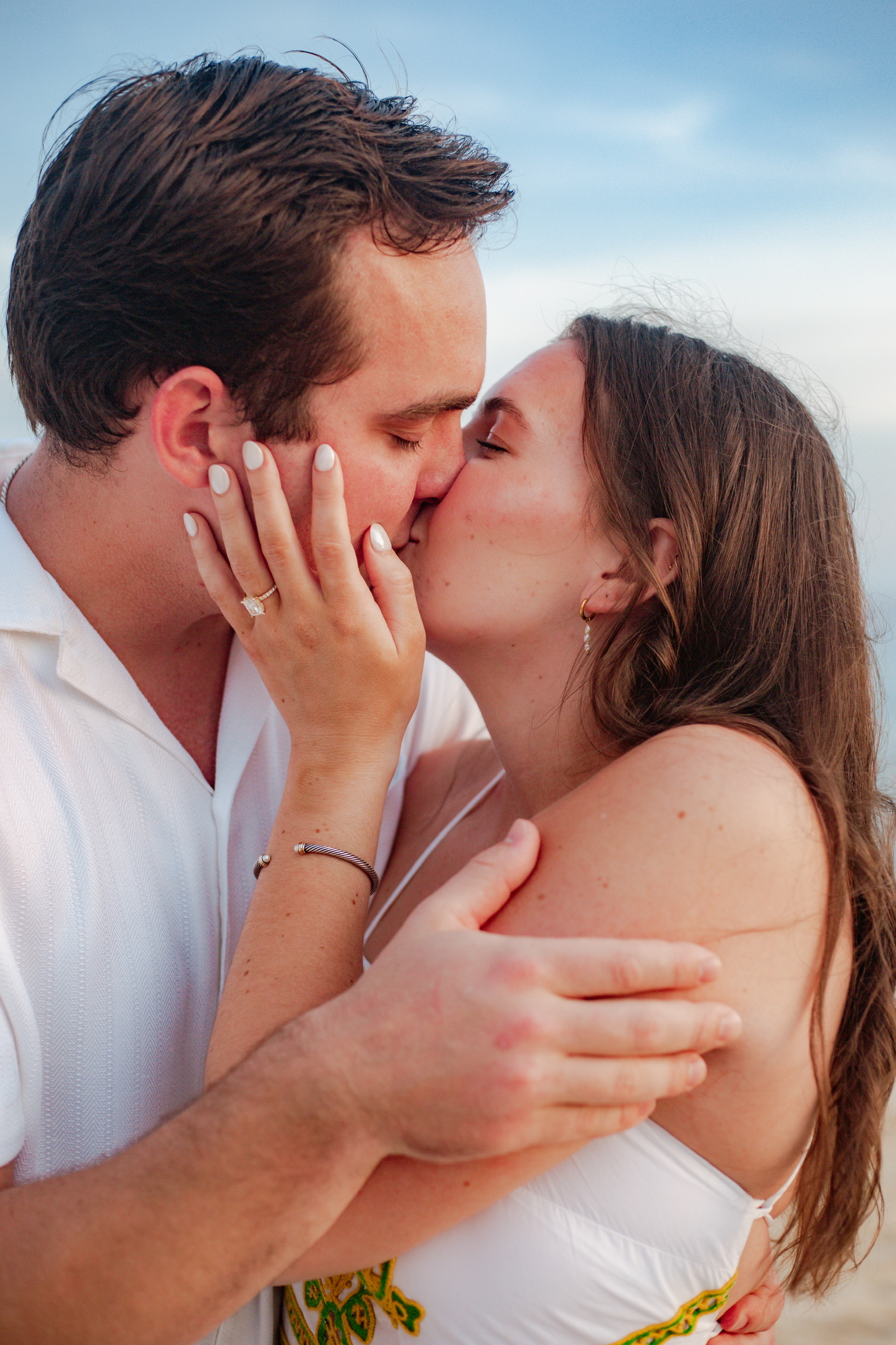 Gianna and Nicholas showing the ring on the beach