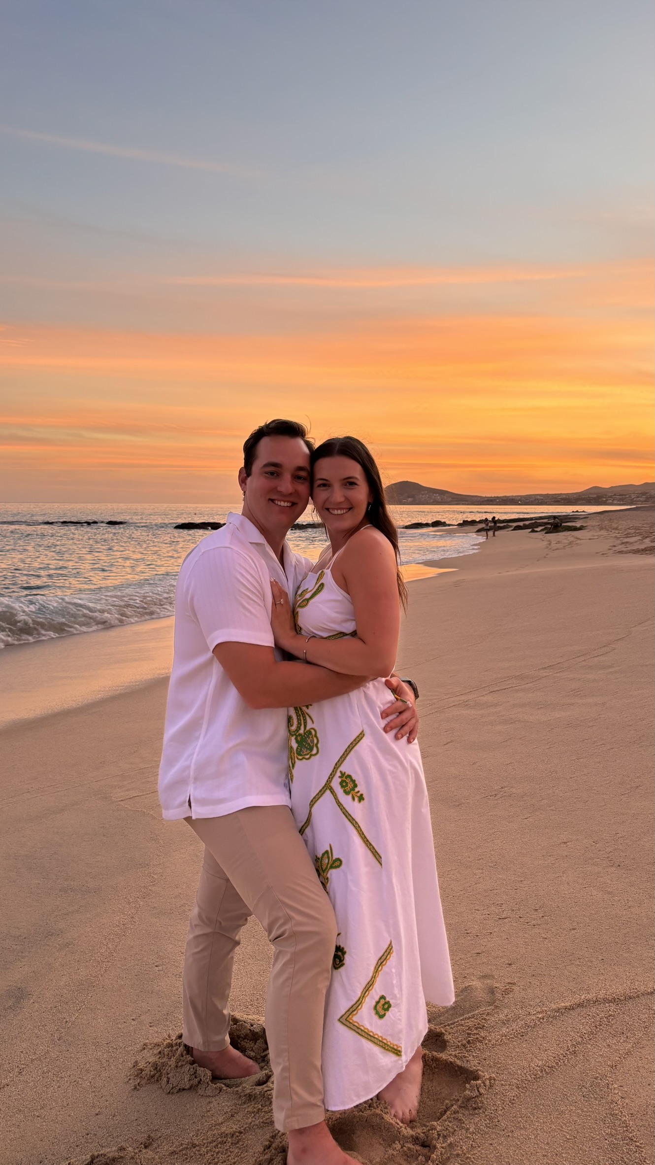 Gianna and Nicholas embracing at sunset